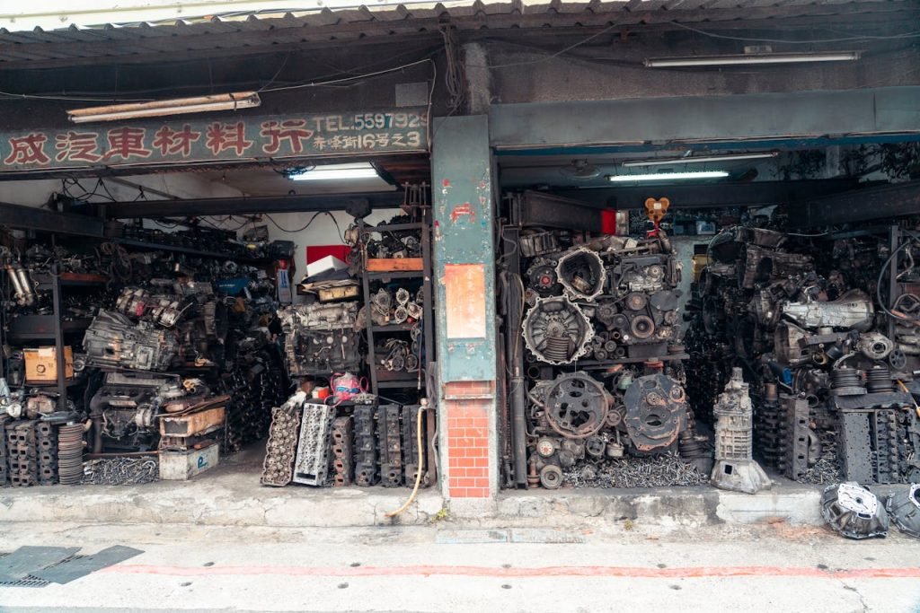 Explore the interior of an industrial workshop brimming with scrap metal and engine parts, showcasing urban decay.